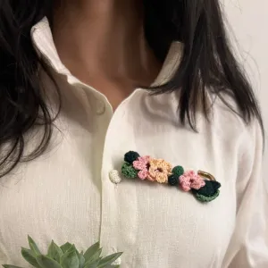 Pink and peach crochet brooch on a metal pin