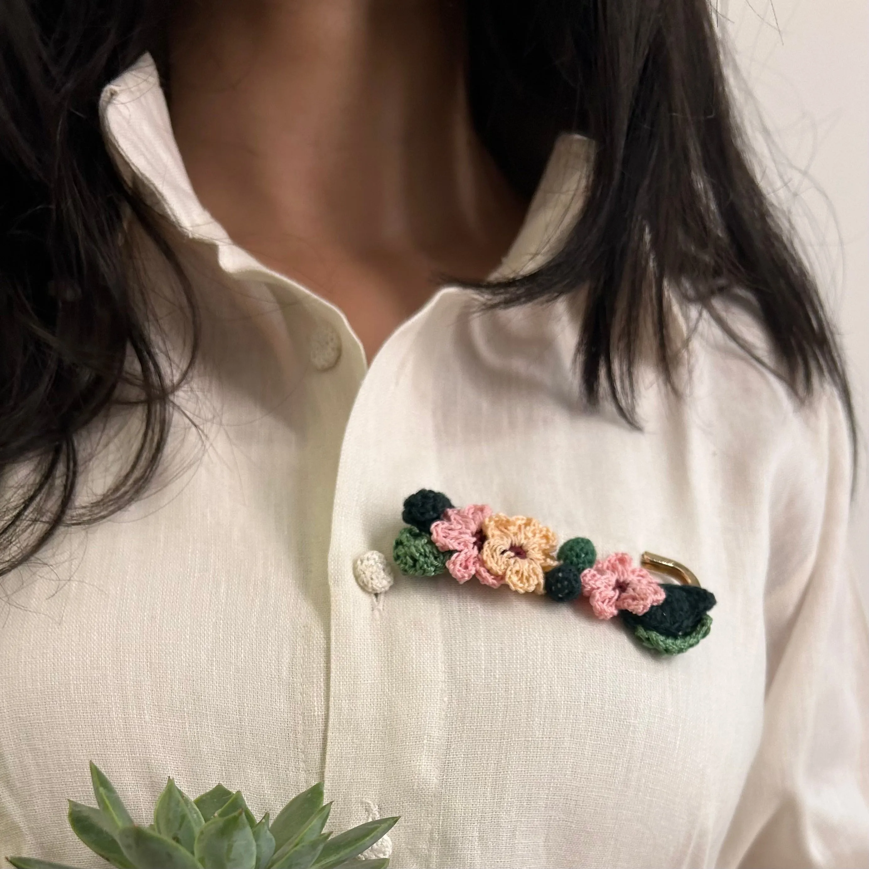Pink and peach crochet brooch on a metal pin